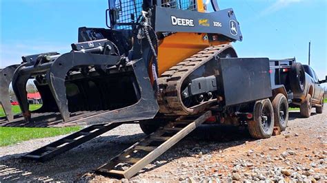 loading a skid steer on a dump trailer|skid steer trailer moving attachment.